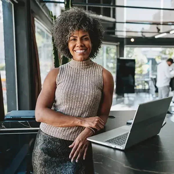 woman smiling with computer