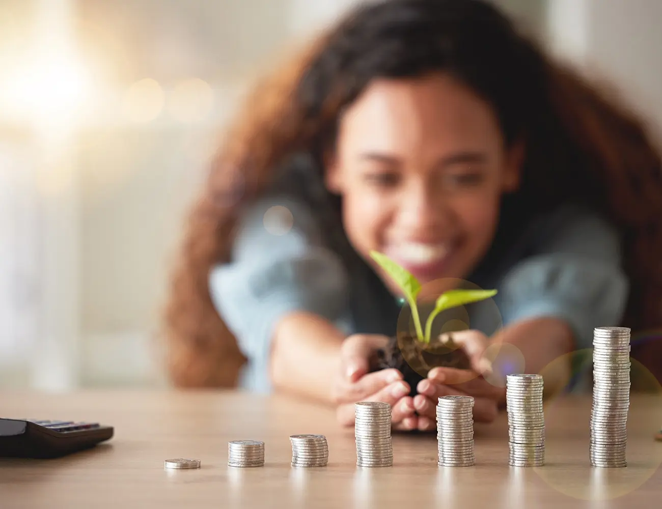 coins and plant in hands