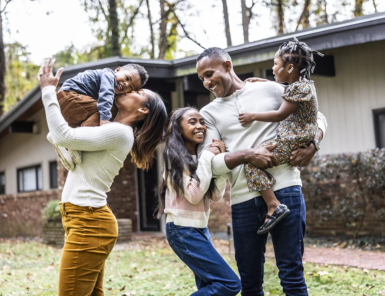 family in front of new home